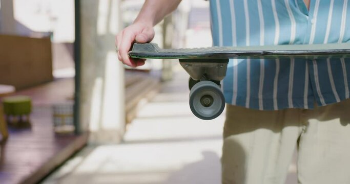 Man rolling his skateboard wheel.