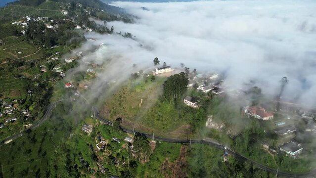 A cloudfall above the mountain village of Haputale in Sri Lanka. Clouds are flowing over the pass. Unusual natural weather phenomenon of falling fog