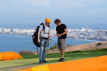 Paragliding teacher teaching a student in a paragliding course