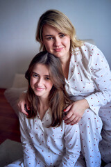 a portrait of a beautiful woman of medium size with a teenage daughter in a minimalist style