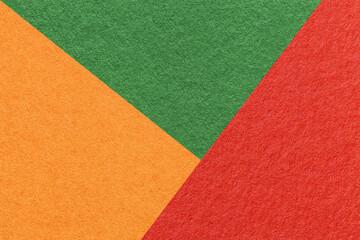 Texture of craft red, green and orange shade color paper background, macro. Vintage abstract cardboard