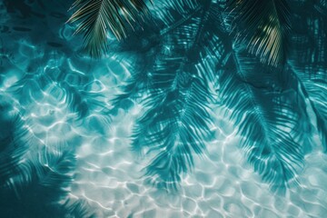 Shadows of tropical leaves on blue water, sand. View from above. Tropical banner with copy space. Abstract background for summer beach weekend.