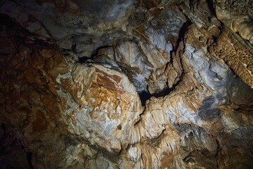 A wild cave inside. Stalactites and stalagmites. Speleology and surveys