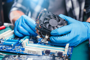 The technician repairing the computer. the concept of computer, CPU, motherboard, hardware,...