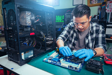 The technician repairing the computer. the concept of computer, CPU, motherboard, hardware,...