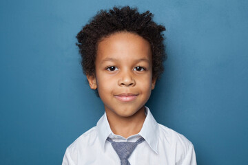 Young kid on blue background, portrait