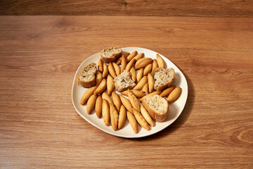 plate with micro rolls called picos and pieces of bread with seeds