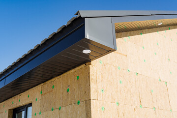 Thermal insulation of the house, exterior view, roof of the house lined with corrugated sheets,...