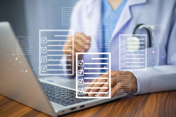 Doctor using laptop for digital document management in office,