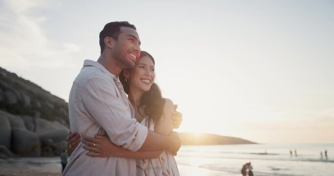 Couple, beach and hug with love on holiday in nature and sightseeing for bonding together by sunset. Man, woman or happy for commitment on honeymoon vacation, embrace or travel for romantic by sea