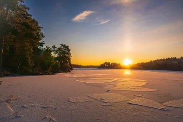 Foto op Canvas Sunrise of a frozen lake, with blue sky, thin cirrus layer, swedish late winter, near Stockholm. Forest and trees. © John