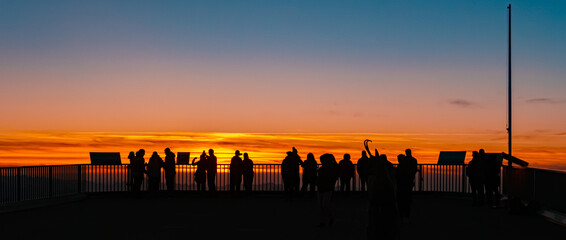 Alpine sunset or sundowner with tourist silhouettes at Mount Zugspitze, Top of Germany,...