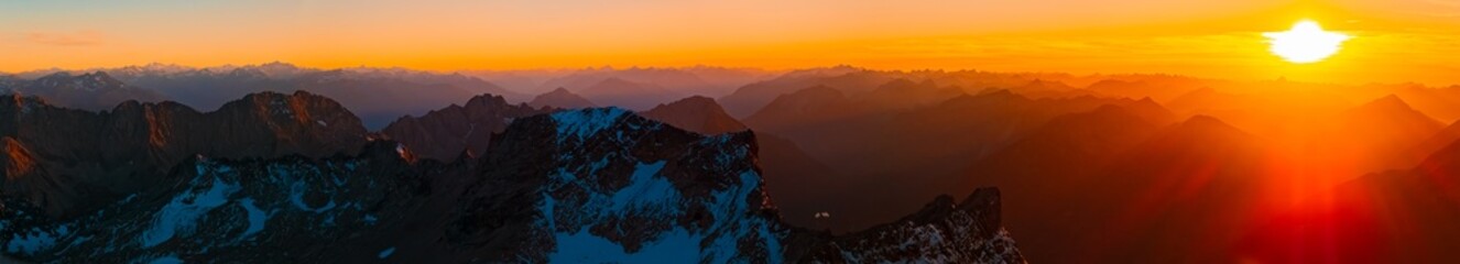 High resolution stitched alpine summer sunset or sundowner panorama at Mount Zugspitze, Top of...