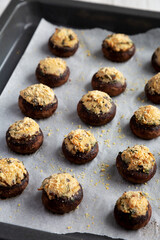Homemade Garlic Parmesan-Stuffed Mushrooms on a baking tray, side view.