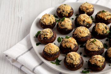 Homemade Garlic Parmesan-Stuffed Mushrooms on a plate, side view.