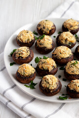 Homemade Garlic Parmesan-Stuffed Mushrooms on a plate, side view.