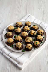 Homemade Garlic Parmesan-Stuffed Mushrooms on a plate, side view.