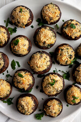Homemade Garlic Parmesan-Stuffed Mushrooms on a plate, top view. Close-up.