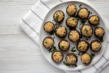 Homemade Garlic Parmesan-Stuffed Mushrooms on a plate, top view. Flat lay, overhead, from above.
