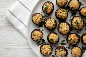 Homemade Garlic Parmesan-Stuffed Mushrooms on a plate, top view. Copy space.