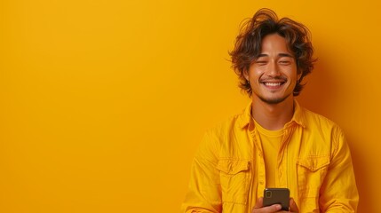 The smiling indian young man is holding a smartphone while ordering online, making a mobile banking payment, and using an advertising application.