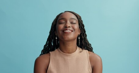 Peace, breathing and happy black woman in studio with gratitude, mindfulness or positive attitude on blue background. Relax, face and African female model with eyes closed zen, smile or stress relief