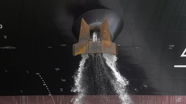 Container ship ballast discharging ballast water out from the Anchor's hub