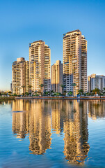 New residential buildings with water reflections at the pond of park in Petah Tikva, Israel.
