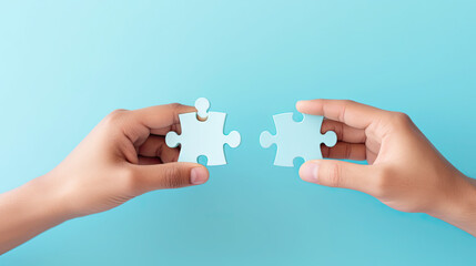 Concept of business collaboration, hands holding a jigsaw puzzle on a pastel blue color background