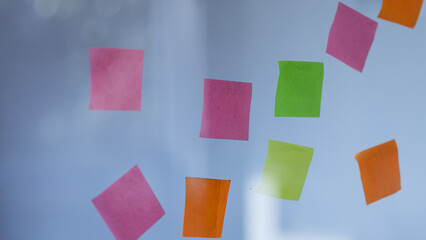 paper notes, Sticking adhesive paper notes on a glass wall.