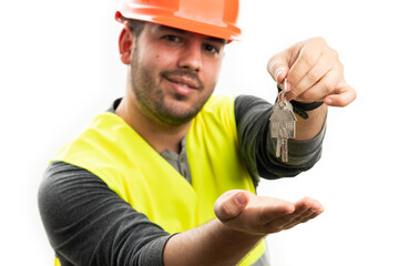 Selective focus close-up constructor presenting keys smiling