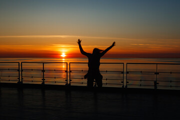 Fototapeta premium Girl silhouette in magical sunset over the Gulf of Finland, Baltic sea.