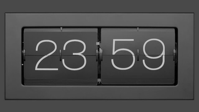 Flip clock quickly flips. Retro flip clock changing from 23:59 to 24:00.. Slow motion. Close up. 