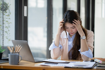 Asian businesswoman are stressed and tired from work at desk in the office, feeling sick at work, stress from work.