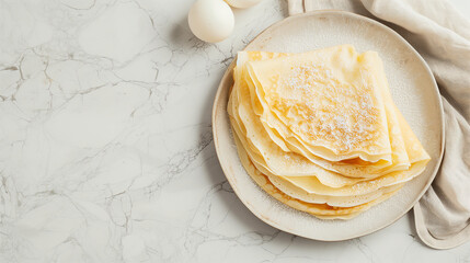 Plate of thin, golden crepes and eggs on a textured white background. Simple and minimalistic breakfast concept with space for text, perfect for food blogs and culinary websites.