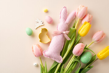 Easter enthusiasts rejoice! A delightful top view display featuring vibrant egg bouquet, cute bunny toy, cookie baking molds, fresh tulips on a soft beige backdrop. Perfect for your festive messages