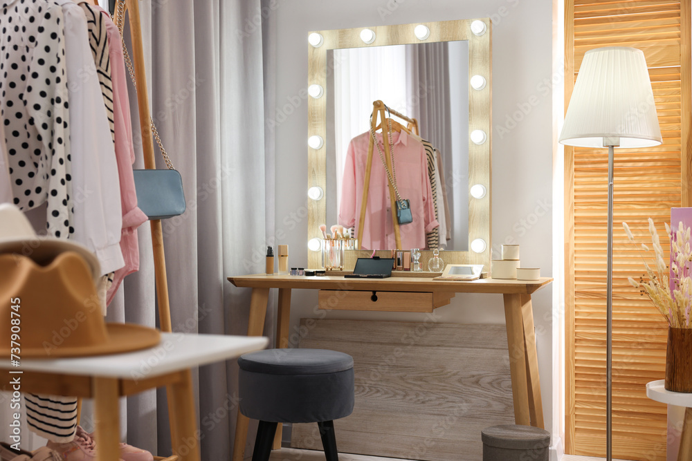 Poster Makeup room. Stylish wooden dressing table with mirror and chair indoors