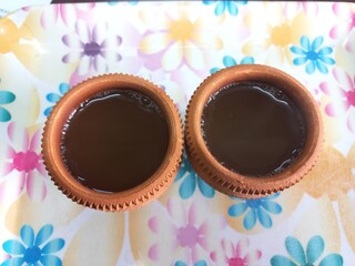 Green tea in clay cup, hot tea clay payali in winter,Desi mud cup of tea in winter Morning, 
Pair of mud cups of tea,Hot tea in winter,close up view of Indian two Mud tea cup in the color background 