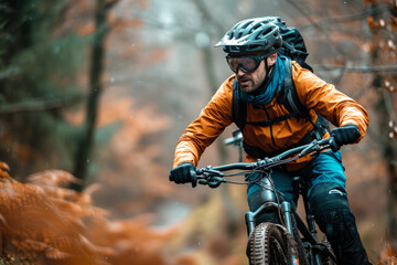 A cyclist rides a mountain bike along a trail in a picturesque autumn forest. Extreme sports and enduro biking concept.