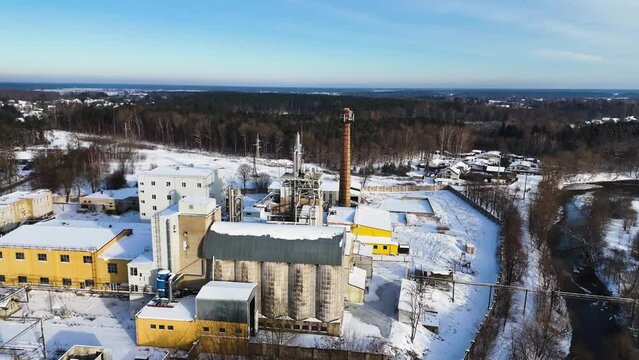 Aerial view of an industrial building with forest background in winter, Silute, Lithuania