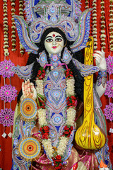 Idol of Goddess Devi Saraswati at a decorated puja pandal in Kolkata, West Bengal, India. Saraswati Puja is a popular religious festival of Hinduism.