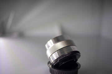 Close-up of camera,Close-up of hand holding camera lens,Old vintage camera placed on a blurred background.