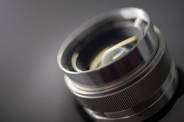 Close-up of camera,Close-up of hand holding camera lens,Old vintage camera placed on a blurred background.