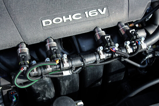 Vinnytsia, Ukraine; February 11, 2024. Close up gas injectors in engine DOHC 16V Hyundai Elantra. Hyundai Elantra 2.0 gas engine parts. Gas injector installed in gasoline engine. Lpg car injectors.