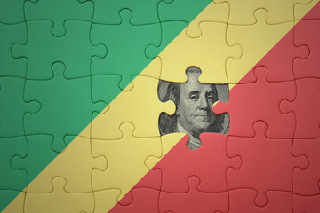 puzzle with the national flag of republic of the congo and usa dollar banknote. finance concept