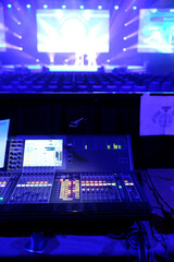 Backstage area at a convention with technical staff handling light and sound