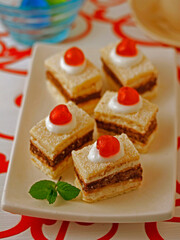Sponge cake with chocolate and cherries.