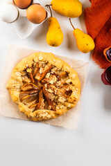 Freshly baked galette with pear on baking paper