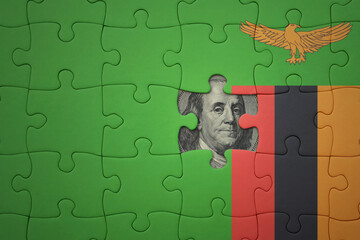 puzzle with the national flag of zambia and usa dollar banknote. finance concept