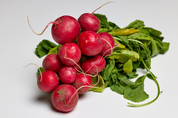 organic red radishes on a white table